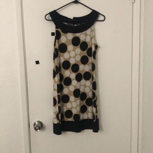 Tan dress with black and white polka dots.